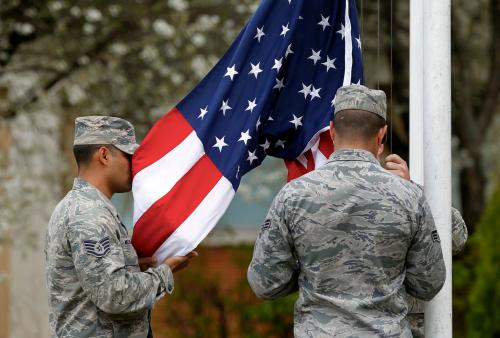 Troops from the U.S. 31st Fighter Wing based at Aviano Air Base in Italy raise their flag during the opening ceremony of bilateral one-week training exercises with Romanian pilots "Dacian Viper 2014" at a military airfield in Campia Turzii in Transylvania, northwest from Romania's northern border with Ukraine, April 10, 2014. U.S and Romanian pilots of fighter jets began one-week military exercises in Romania as scheduled in operations planned before the Russian annexation of Ukraine's Crimea, officials said on Thursday.